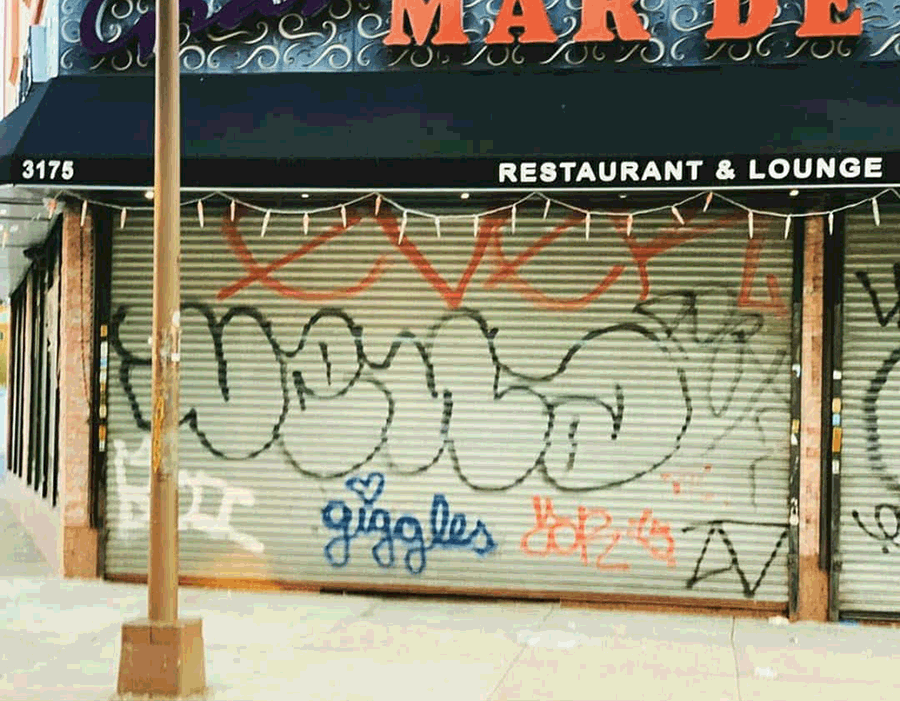 1990s street graffiti on a storefront gate, which has been rolled down for the first time in many years. On the gate are tags by VENA FTR, EVER NVA, POET 156 CWK, GIGGLES, and ZD. Photo courtesy of VENA FTR.